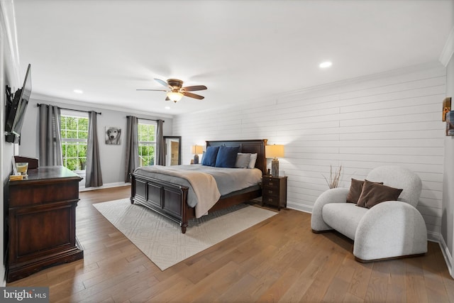 bedroom featuring recessed lighting, ornamental molding, and wood finished floors