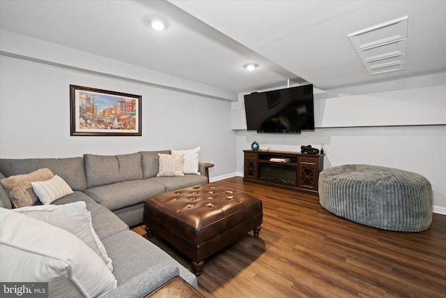 living room featuring recessed lighting, baseboards, and wood finished floors