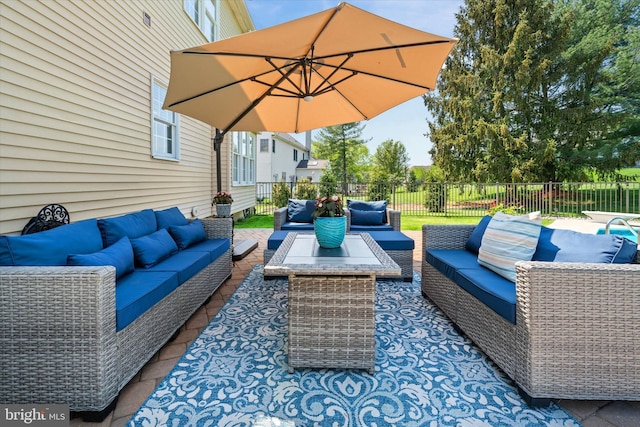view of patio featuring outdoor lounge area and fence