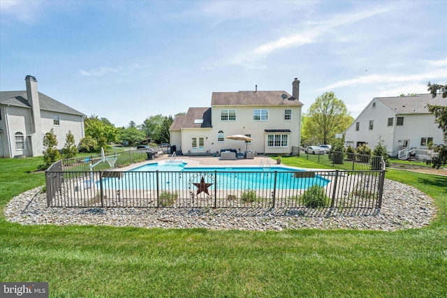 view of swimming pool with fence, a fenced in pool, french doors, a patio, and a yard