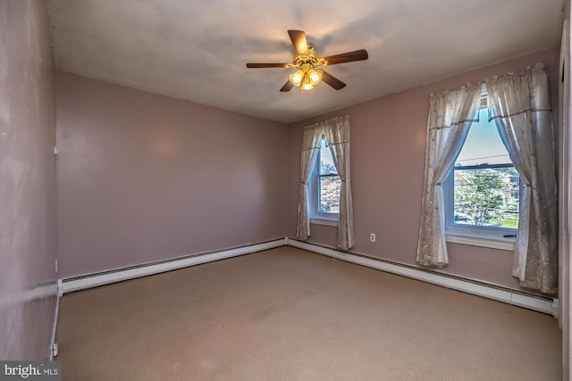 carpeted spare room with a healthy amount of sunlight, ceiling fan, and a baseboard radiator