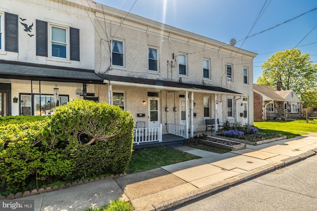 multi unit property with covered porch and stucco siding