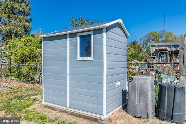 view of shed with fence