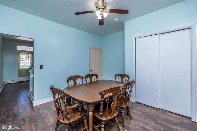 dining area with dark wood-style flooring, a ceiling fan, and baseboards