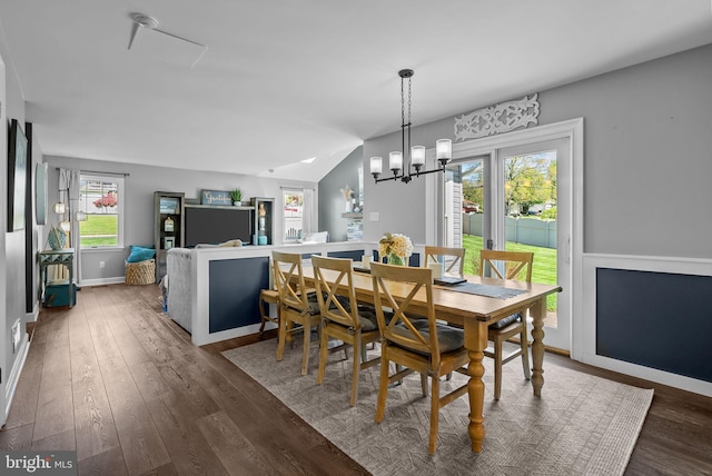 dining area featuring baseboards, a notable chandelier, and wood finished floors