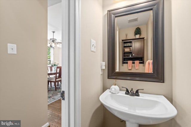 bathroom with visible vents, a sink, and wood finished floors