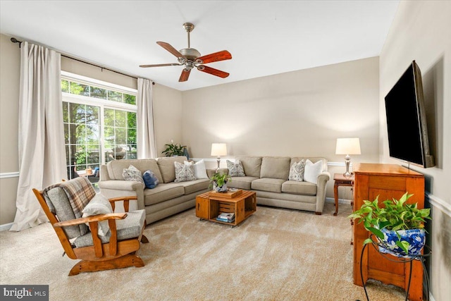 carpeted living room featuring ceiling fan
