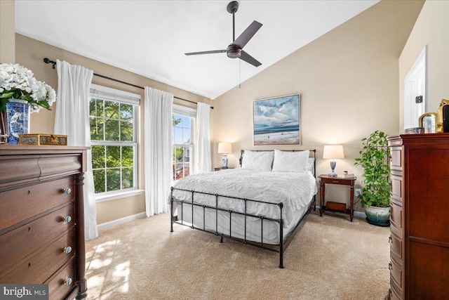 bedroom featuring baseboards, a ceiling fan, lofted ceiling, and light carpet