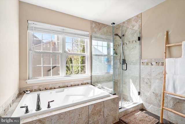 bathroom featuring a bath and a stall shower