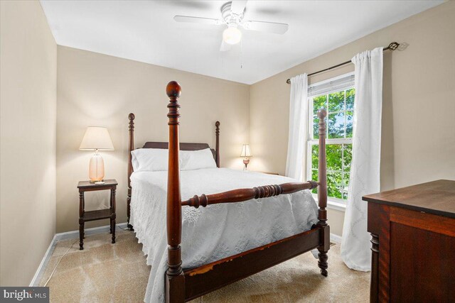bedroom featuring baseboards, light carpet, and a ceiling fan