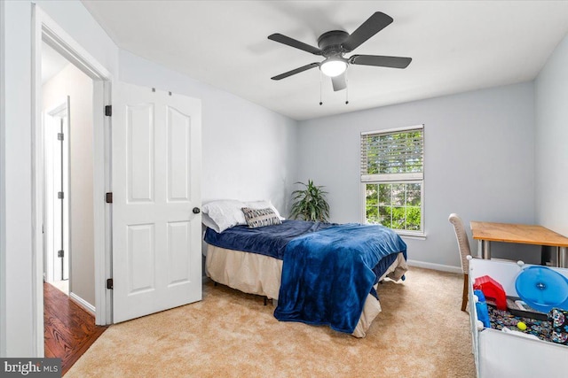 bedroom featuring a ceiling fan, baseboards, and carpet