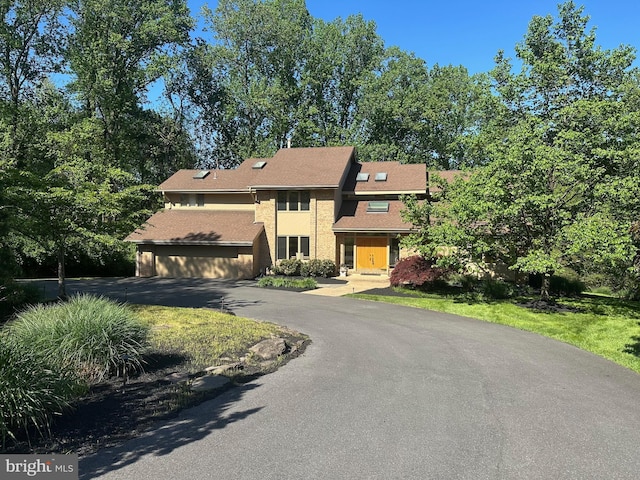 view of front of property with driveway and a garage