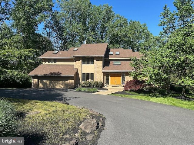 view of front of home featuring driveway and a garage