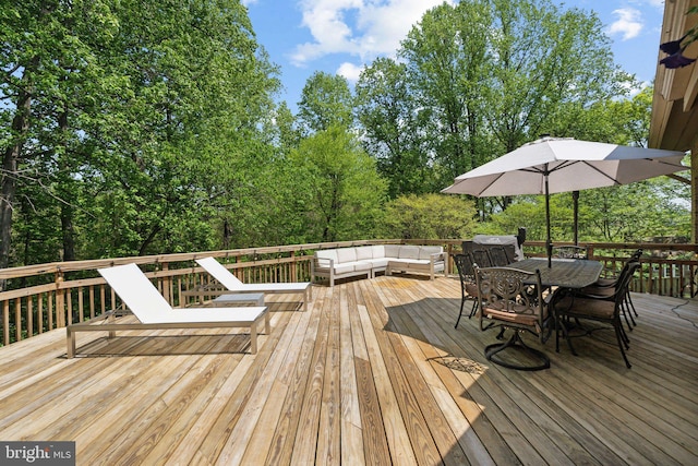 wooden deck featuring outdoor dining area and an outdoor living space