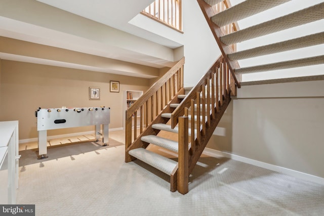 stairs with carpet floors and baseboards