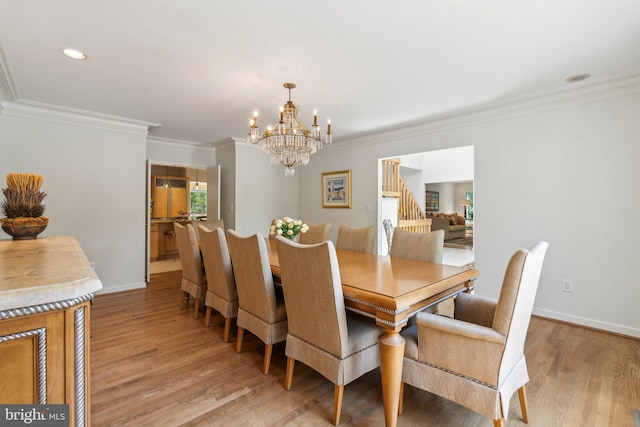 dining room with an inviting chandelier, light wood-style flooring, stairs, baseboards, and ornamental molding