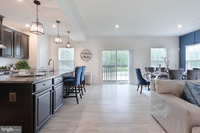 5735 River Shark Ln, Waldorf, MD 20602 - kitchen featuring open floor plan, a breakfast bar, healthy amount of natural light, light wood-style flooring, and recessed lighting
