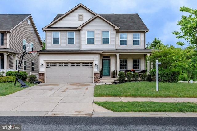 5735 River Shark Ln, Waldorf, MD 20602 - view of front of property with concrete driveway, a front yard, a garage, and stone siding