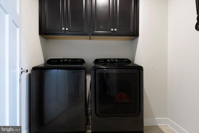 5735 River Shark Ln, Waldorf, MD 20602 - clothes washing area featuring independent washer and dryer, baseboards, and cabinet space