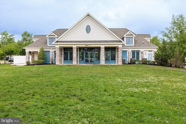 5735 River Shark Ln, Waldorf, MD 20602 - view of front facade featuring french doors, a front yard, a shingled roof, and stone siding