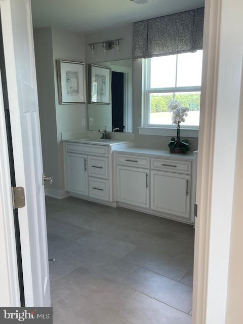 bathroom with tile patterned floors and vanity