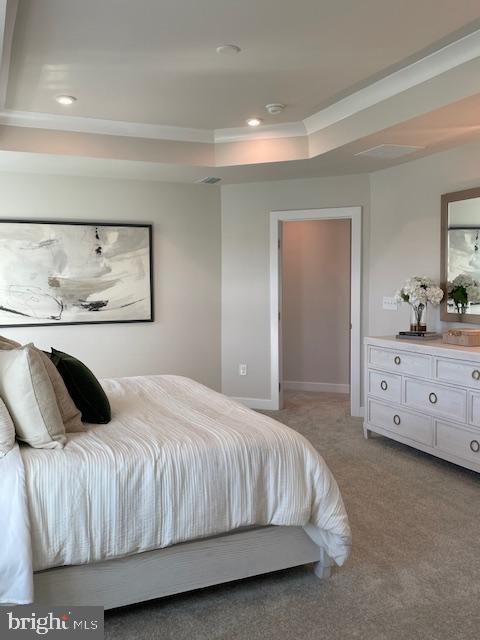 bedroom featuring recessed lighting, light colored carpet, a raised ceiling, and baseboards