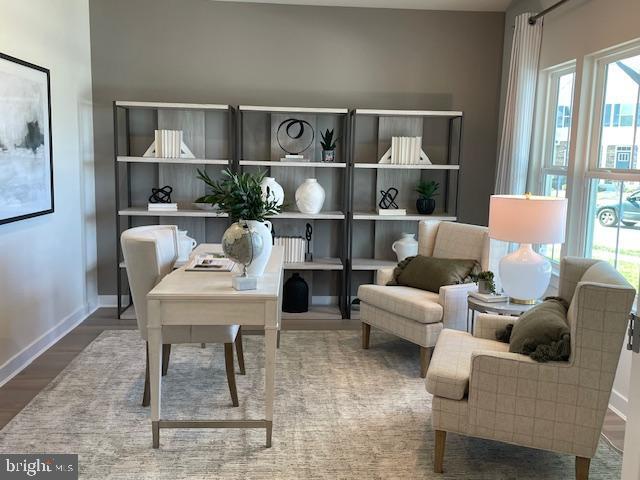 office space with wood finished floors and baseboards