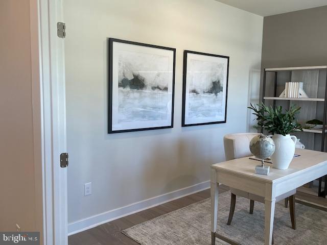 office space with baseboards and wood finished floors