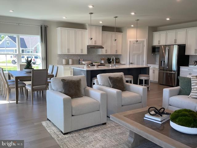 living room with recessed lighting and light wood-type flooring