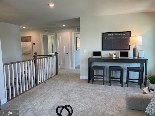 living room featuring baseboards, recessed lighting, visible vents, and carpet flooring