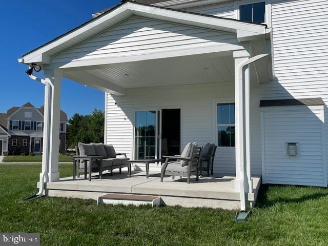 rear view of house featuring a lawn and outdoor lounge area