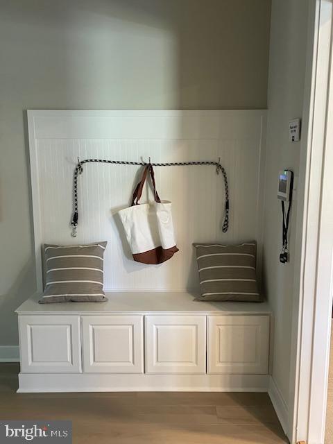 mudroom featuring wood finished floors and baseboards