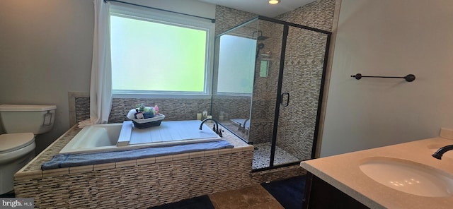 full bathroom with a shower stall, toilet, a bath, and vanity
