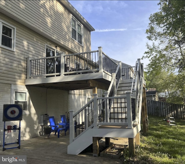 exterior space with a patio, stairs, and fence