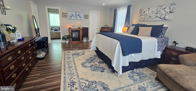 bedroom with dark wood-style floors, recessed lighting, and baseboards