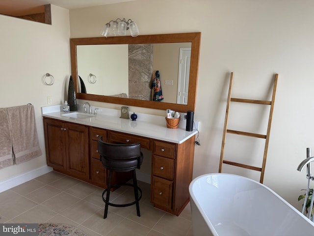 full bath featuring tile patterned floors, vanity, and a soaking tub