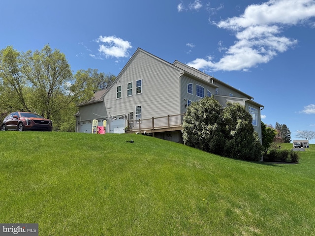 view of home's exterior with a garage and a yard