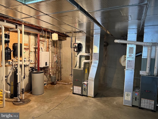 utility room with heating unit and water heater