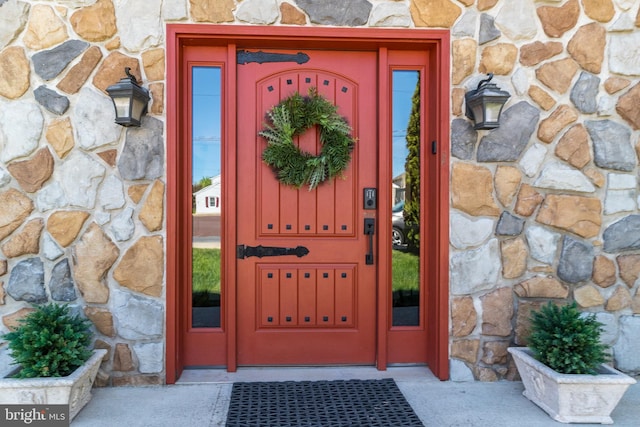 entrance to property featuring stone siding