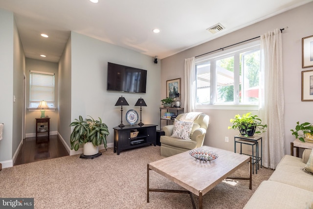 carpeted living room featuring baseboards, recessed lighting, and visible vents