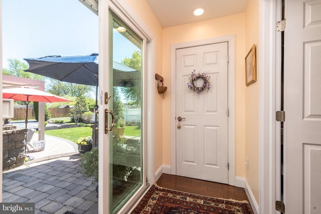 doorway featuring recessed lighting and baseboards
