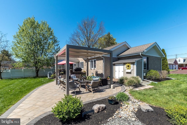 rear view of house featuring an outdoor living space, fence, a yard, a patio, and stucco siding