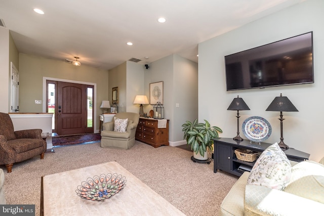 carpeted living area featuring baseboards, recessed lighting, and visible vents
