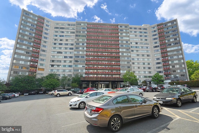 view of building exterior featuring uncovered parking