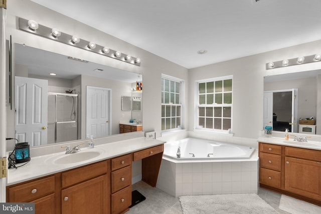6028 Toomey Ln, Elkridge, MD 21075 - bathroom with a jetted tub, a shower stall, two vanities, a sink, and tile patterned floors
