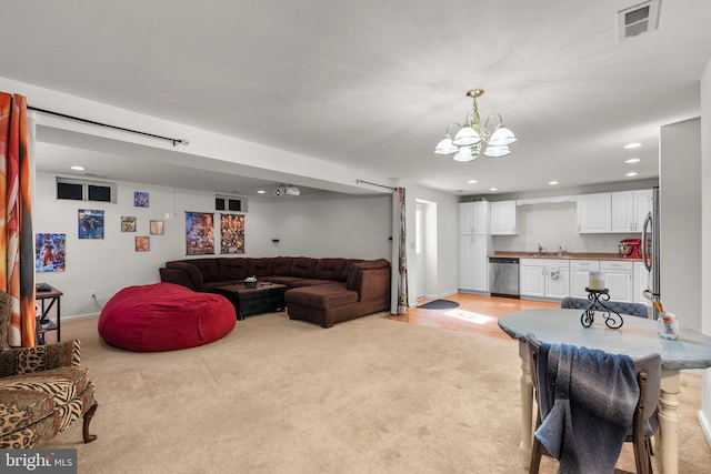 6028 Toomey Ln, Elkridge, MD 21075 - living area with light colored carpet, recessed lighting, and an inviting chandelier