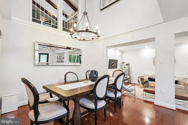 15109 Watergate Rd, Silver Spring, MD 20905 - dining area featuring a chandelier, wood finished floors, and baseboards