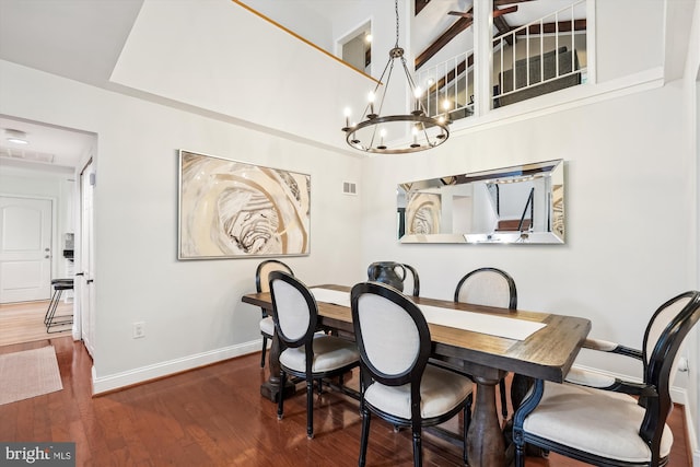 15109 Watergate Rd, Silver Spring, MD 20905 - dining room with baseboards, wood finished floors, a chandelier, and vaulted ceiling