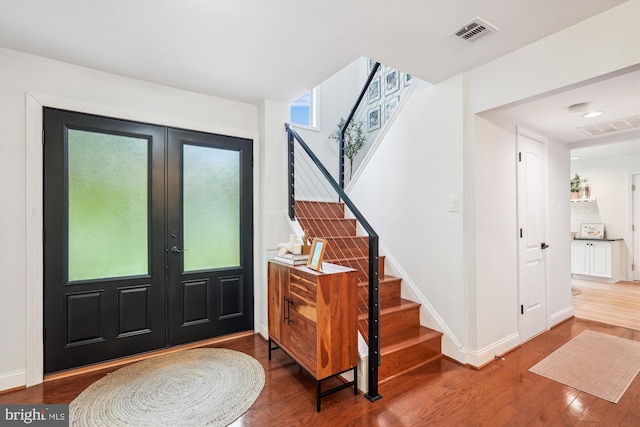 15109 Watergate Rd, Silver Spring, MD 20905 - foyer entrance with wood finished floors, stairs, french doors, and baseboards
