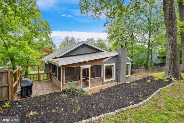 15109 Watergate Rd, Silver Spring, MD 20905 - back of house featuring a sunroom, a wooden deck, a chimney, and fence